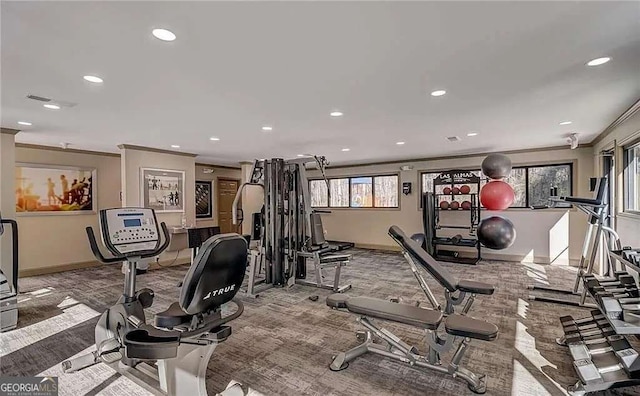 exercise room with light carpet and ornamental molding