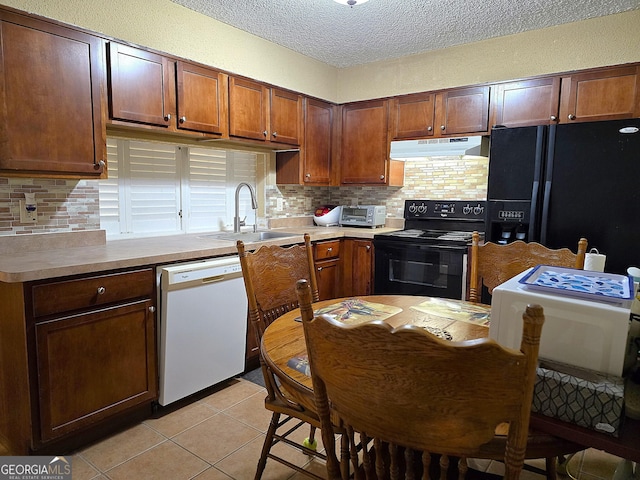 kitchen featuring electric range, light tile patterned flooring, white dishwasher, a textured ceiling, and sink