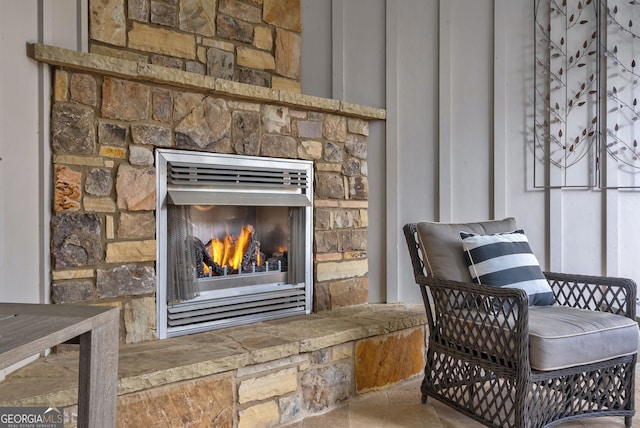 living area featuring a stone fireplace