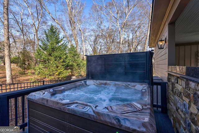 wooden deck featuring a hot tub