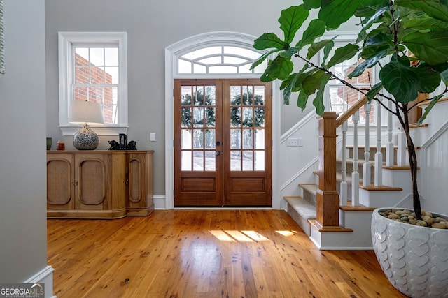 entrance foyer featuring french doors and light hardwood / wood-style flooring