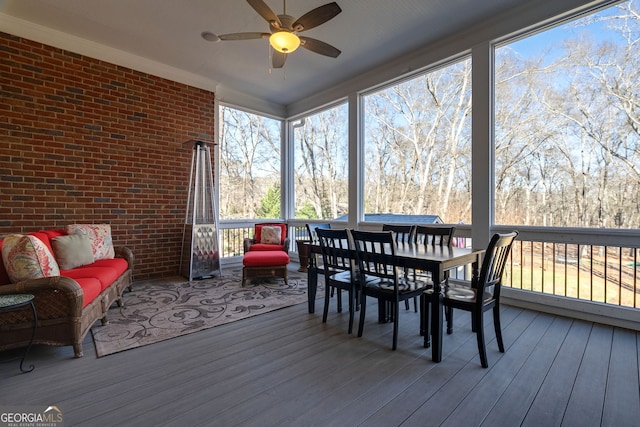 sunroom / solarium featuring ceiling fan