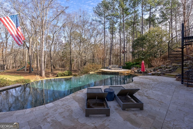 view of swimming pool with a patio area