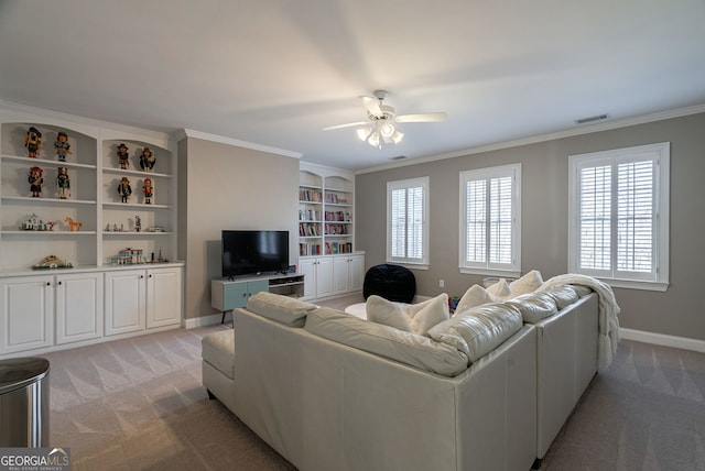 carpeted living room featuring ceiling fan, built in features, and ornamental molding