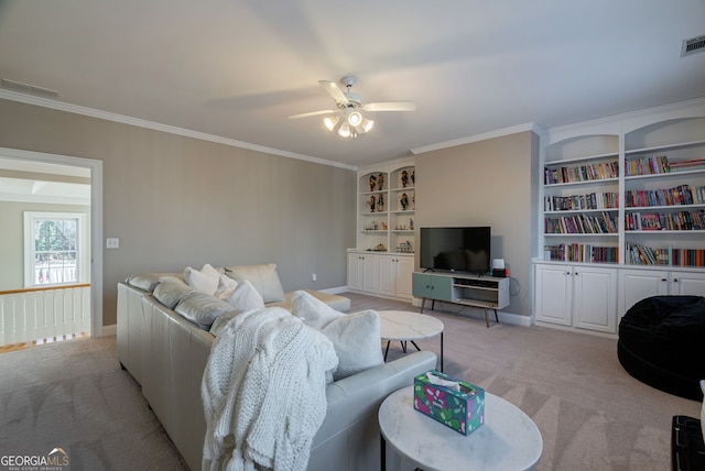 carpeted living room with ceiling fan and crown molding