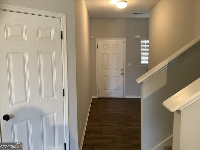 corridor featuring dark hardwood / wood-style flooring