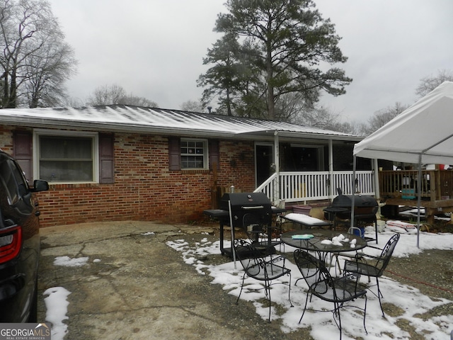 view of snow covered back of property