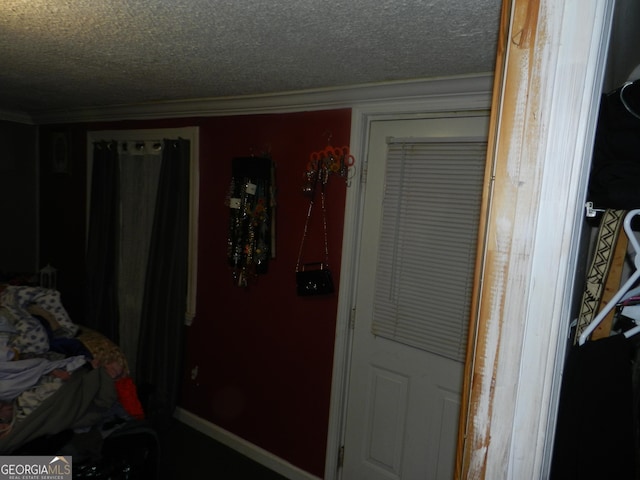 bedroom with ornamental molding and a textured ceiling