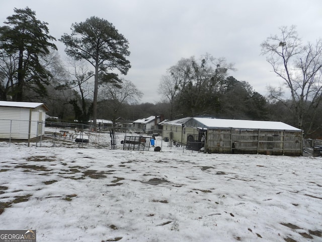 yard covered in snow with an outdoor structure