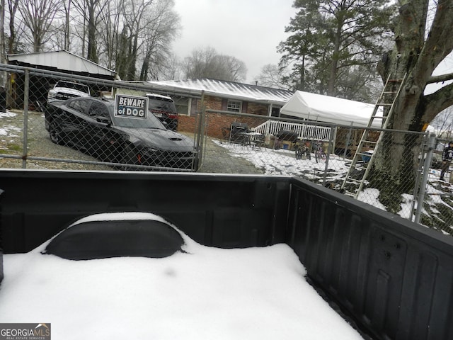 view of snow covered back of property