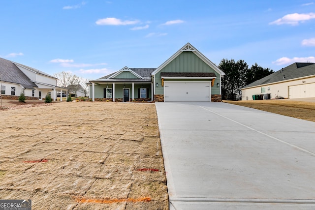 view of front of property featuring a porch, a garage, and cooling unit