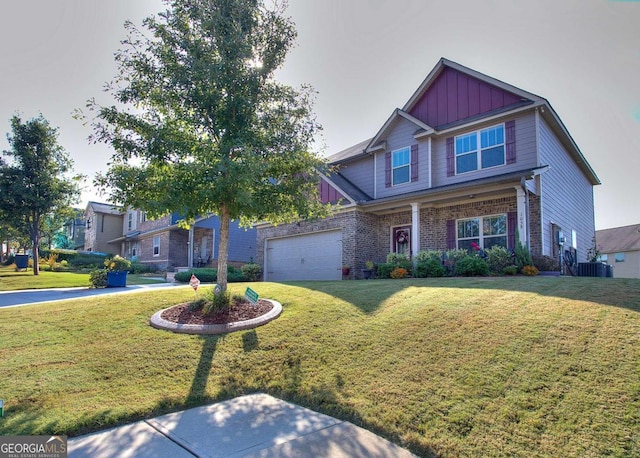 craftsman-style home with a front yard, central AC, and a garage