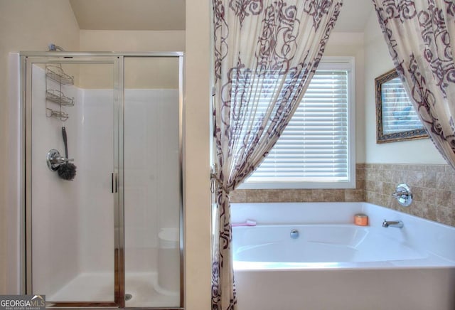 bathroom with separate shower and tub and plenty of natural light