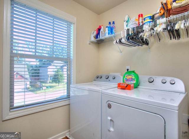 clothes washing area featuring plenty of natural light and independent washer and dryer