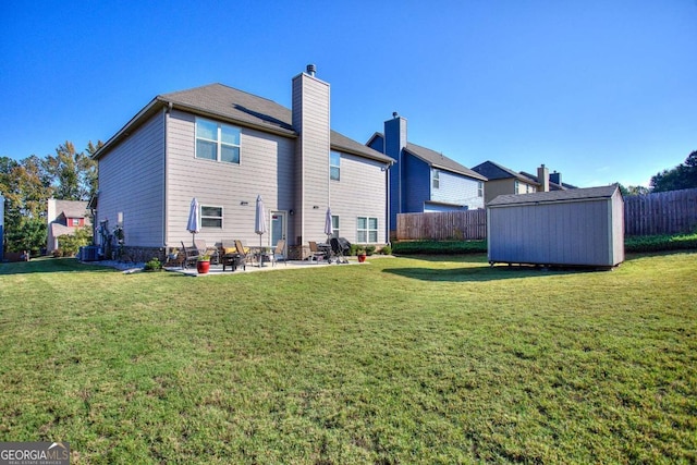 rear view of property featuring a patio area, a storage shed, and a lawn