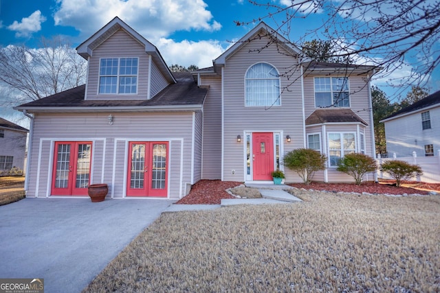 view of front facade featuring a front yard and french doors