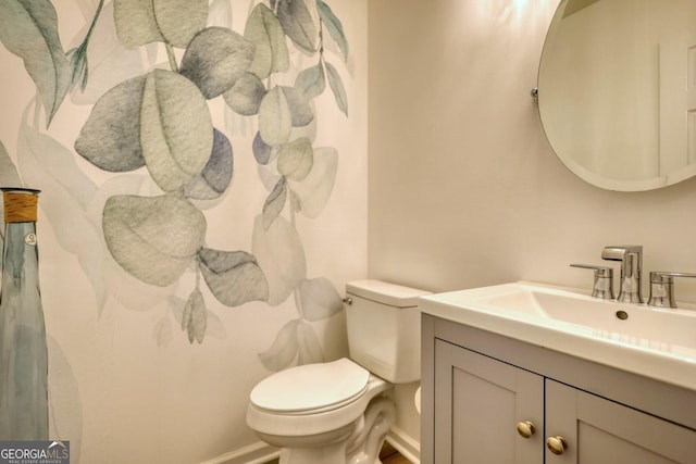 bathroom featuring toilet and vanity