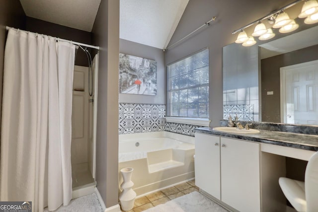 bathroom featuring vanity, vaulted ceiling, tile patterned floors, and shower with separate bathtub