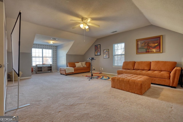 living room featuring carpet flooring, ceiling fan, and plenty of natural light