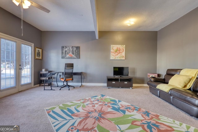 living room with a textured ceiling, french doors, carpet flooring, ceiling fan, and beamed ceiling