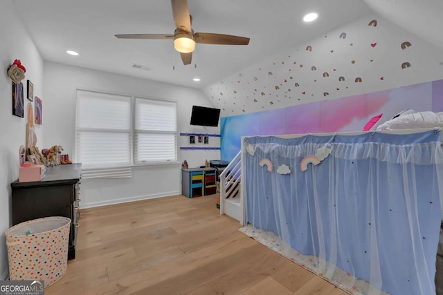 bedroom featuring vaulted ceiling, ceiling fan, and light wood-type flooring