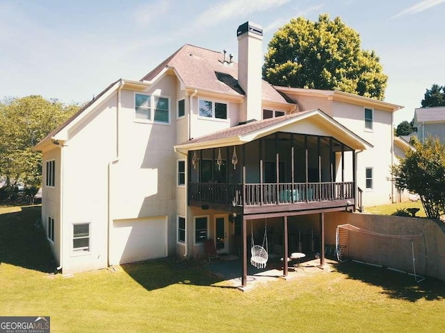 rear view of property with a lawn and a sunroom