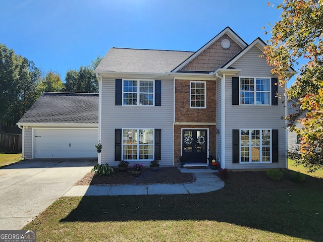 view of front of property with a front lawn and a garage