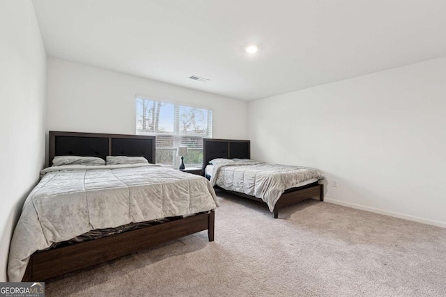 bedroom with light colored carpet