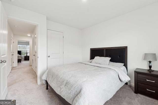 bedroom featuring light carpet