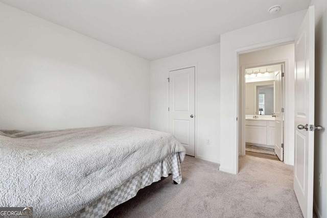 bedroom with light colored carpet and connected bathroom