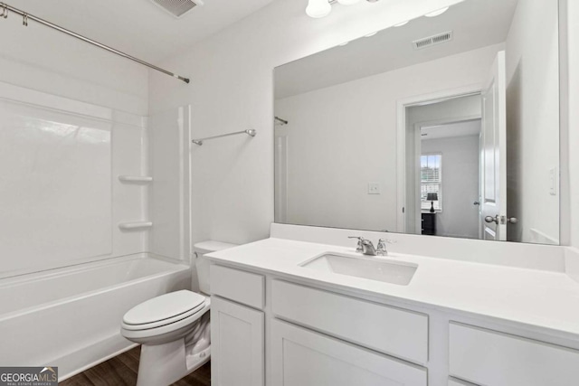 full bathroom featuring shower / washtub combination, vanity, hardwood / wood-style floors, and toilet