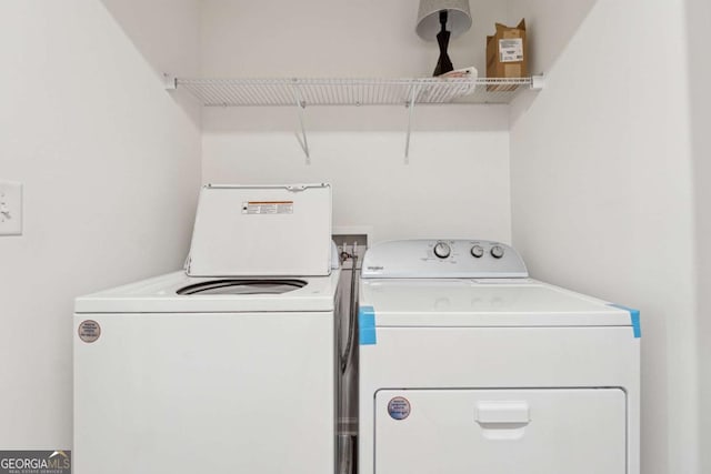 laundry area featuring washing machine and clothes dryer