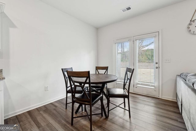 dining room with dark hardwood / wood-style flooring