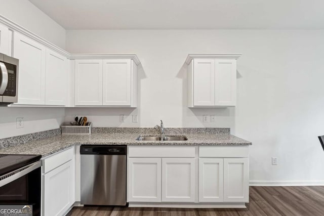 kitchen with white cabinets, sink, light stone countertops, and stainless steel appliances