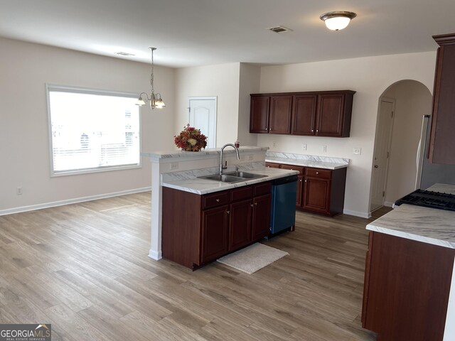 kitchen featuring light hardwood / wood-style floors, sink, hanging light fixtures, a chandelier, and stainless steel dishwasher