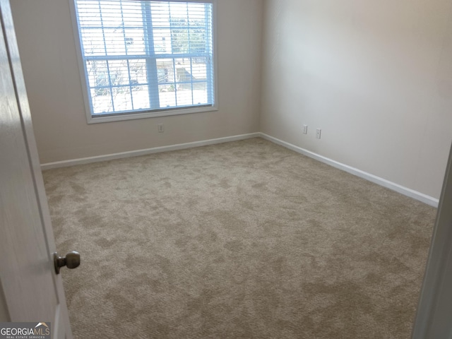 spare room with carpet floors and baseboards