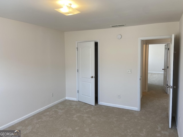 unfurnished bedroom featuring light colored carpet