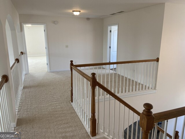 corridor featuring light colored carpet