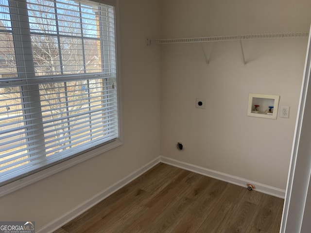 laundry room with dark hardwood / wood-style floors, a wealth of natural light, hookup for a washing machine, and electric dryer hookup