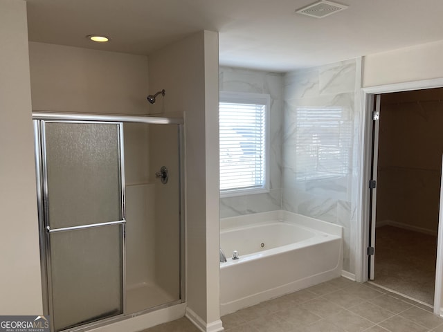 full bath featuring tile patterned floors, visible vents, a shower stall, and a bath