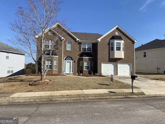 view of front of house with driveway, an attached garage, and brick siding