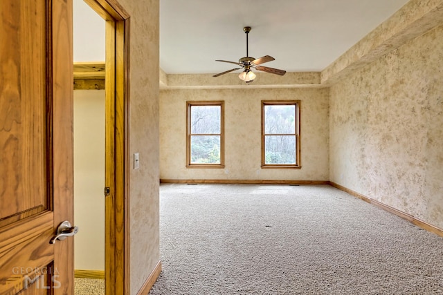 carpeted empty room featuring ceiling fan