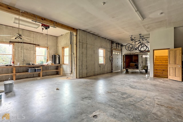 misc room featuring a workshop area, ceiling fan, and concrete floors