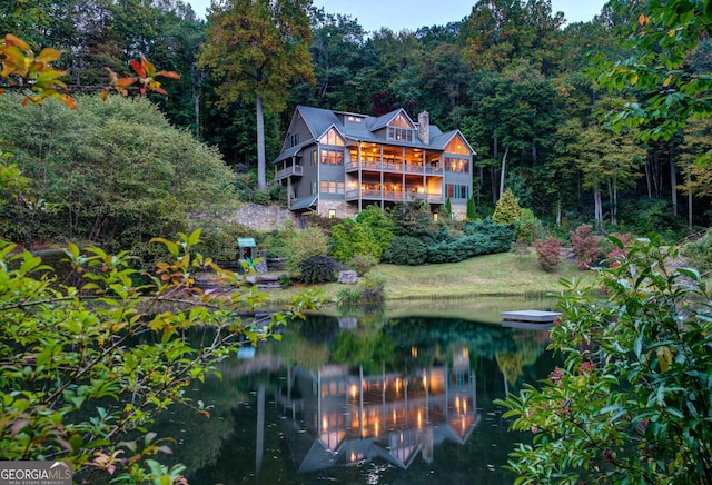 rear view of property with a water view