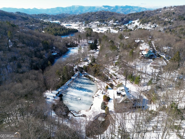 snowy aerial view with a mountain view