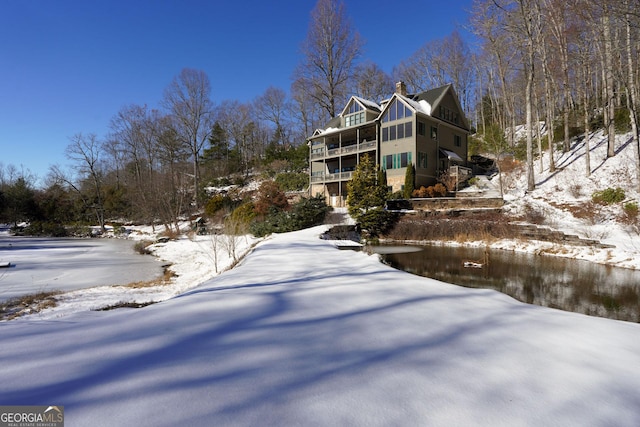 view of snowy exterior with a balcony