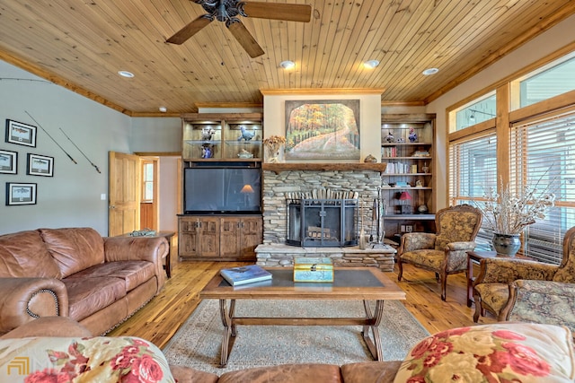 living room with a fireplace, light hardwood / wood-style flooring, crown molding, and wood ceiling