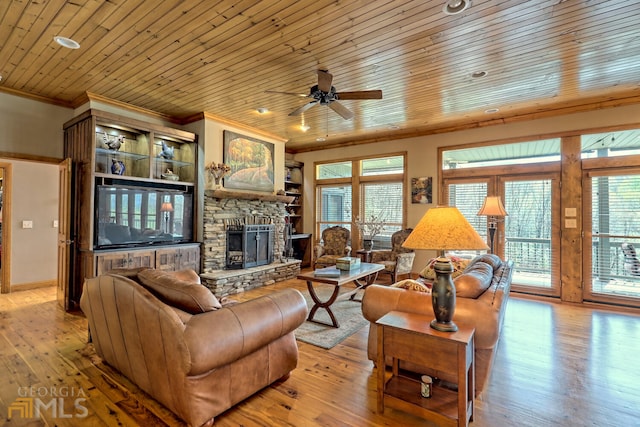 living room featuring a wealth of natural light, ceiling fan, light hardwood / wood-style flooring, and wooden ceiling