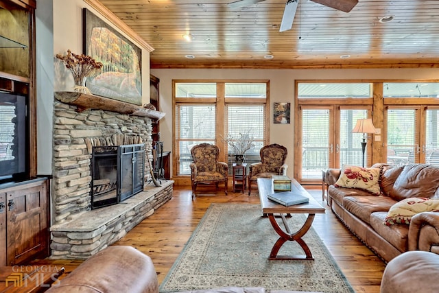 living room with a fireplace, ceiling fan, light hardwood / wood-style flooring, and wooden ceiling