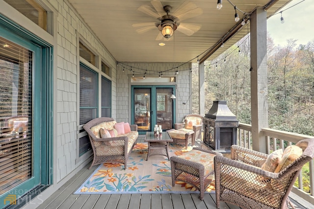 deck featuring outdoor lounge area and ceiling fan